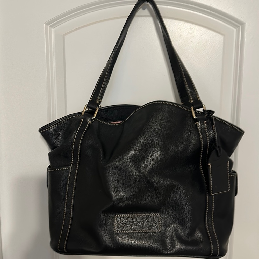 Dooney and Bourke Black all weather leather tote bag with luggage tag